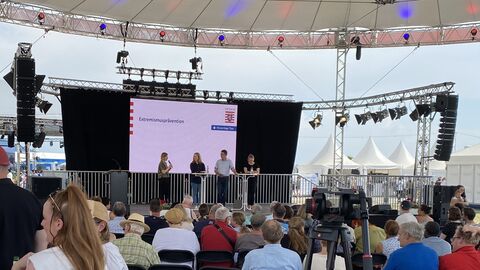Bühnenveranstaltung des LfV Hessen zum Thema "Reichsbürger und Selbstverwalter" auf dem Hessentag in Pfungstadt vor "vollem Haus". Bühnenveranstaltung des LfV Hessen zum Thema "Reichsbürger und Selbstverwalter" auf dem Hessentag in Pfungstadt. Zu sehen sind von links nach rechts die PMK-Expertin des PP Südhessen, die Leiterin der DEXT-Stelle Darmstadt-Dieburg, sowie ein Pressesprecherin und eine Dezernatsleiterin aus der Präventionsabteilung des LfV Hessen.